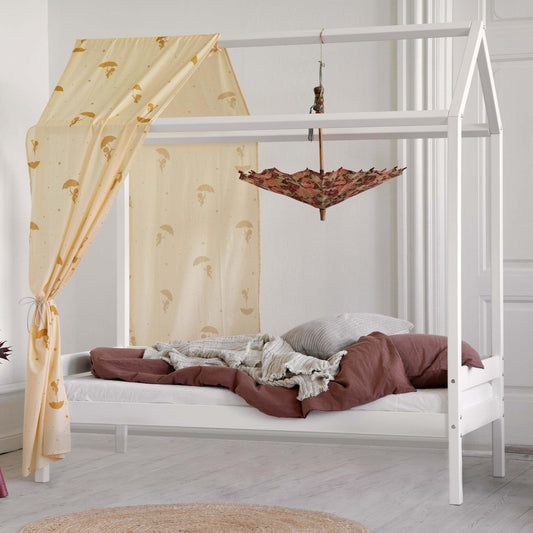 house bed in white with textiles in a white room background