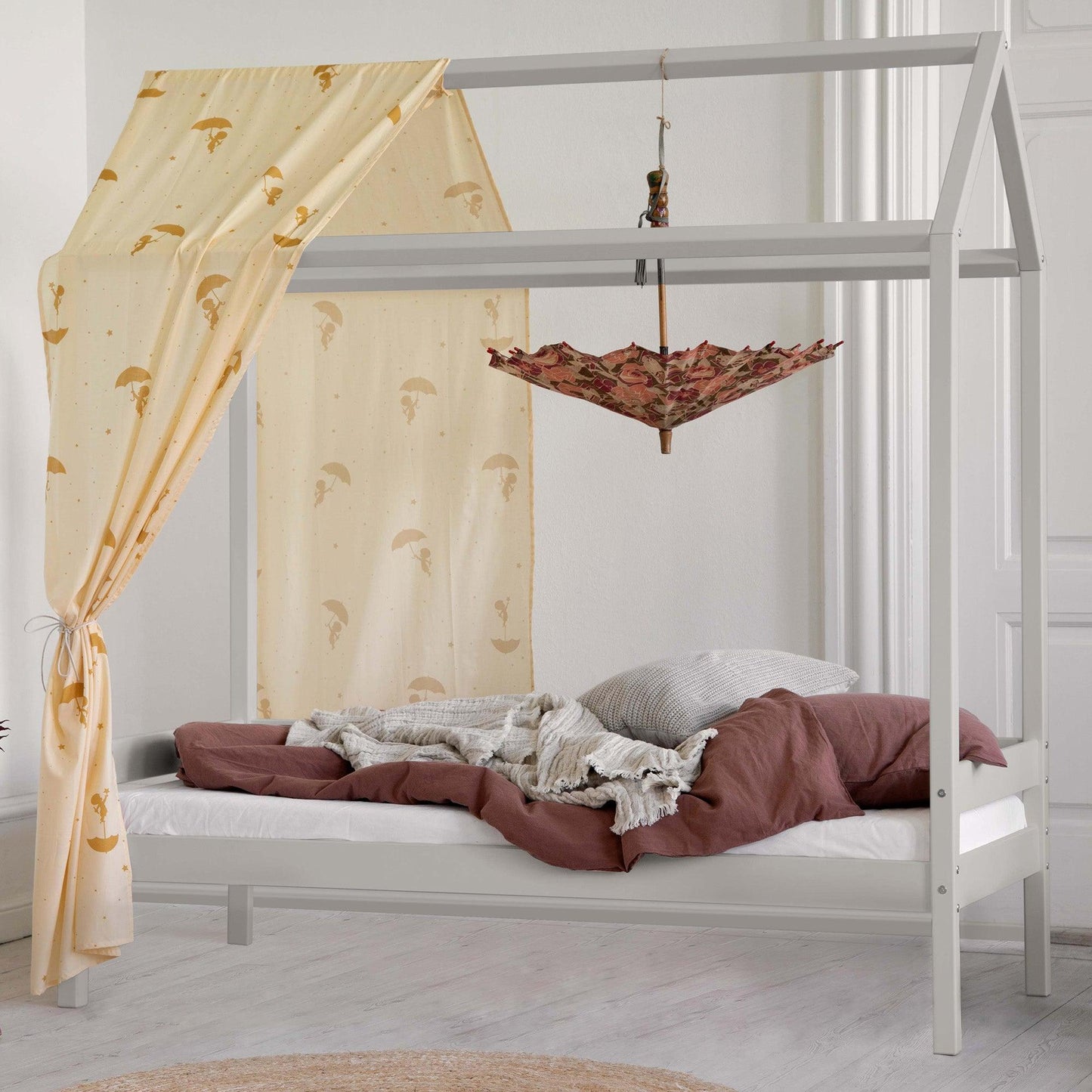 house bed in dove grey with textiles in a white room background